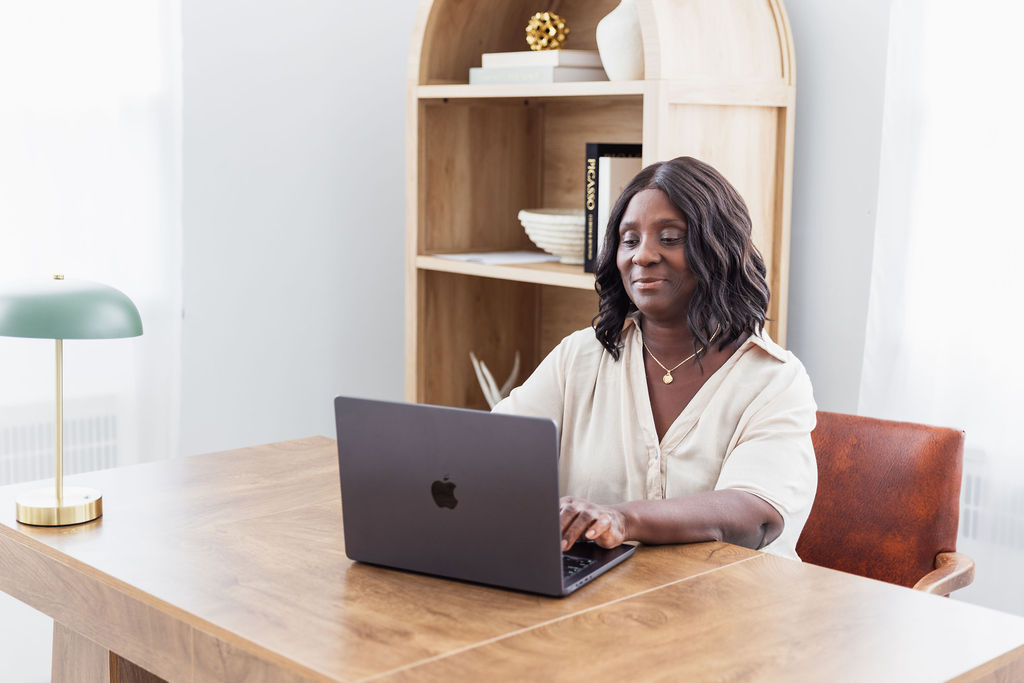 Dorcas Haizel, Founder and CEO of EduSetCare, working at her desk